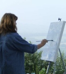 Lyn at her easel painting the 'Landscape'